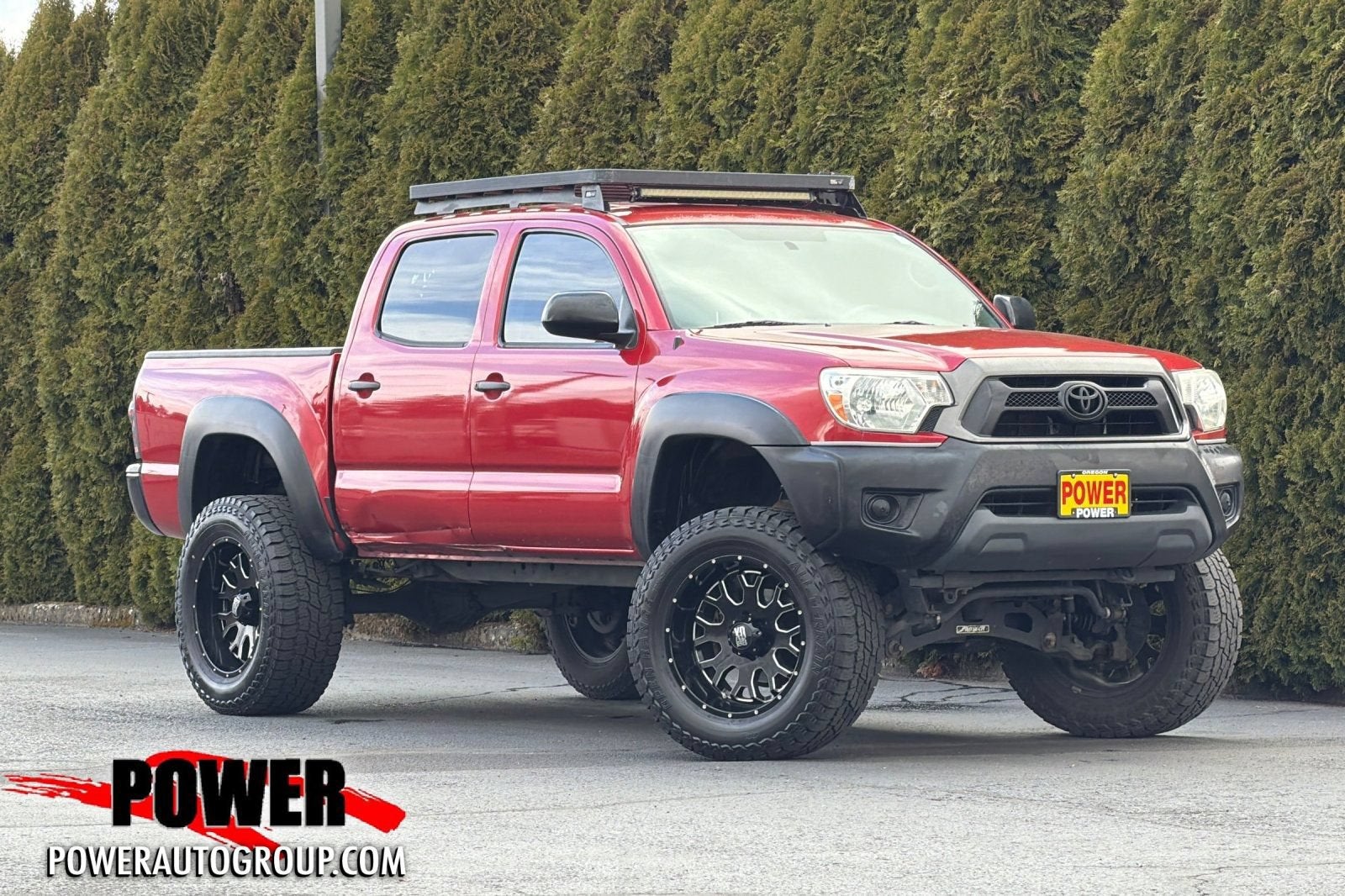 2012 Toyota Tacoma DBL CAB 4WD V6 AT in Barcelona Red M — front three-quarter view