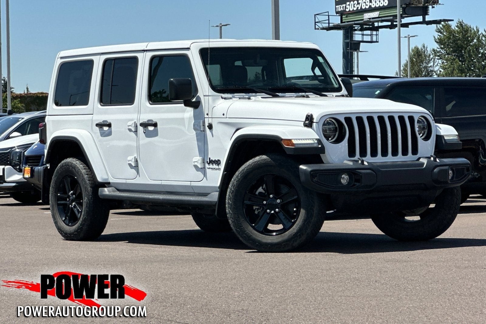 2022 Jeep Wrangler Unlimited Sahara in White — front three-quarter view