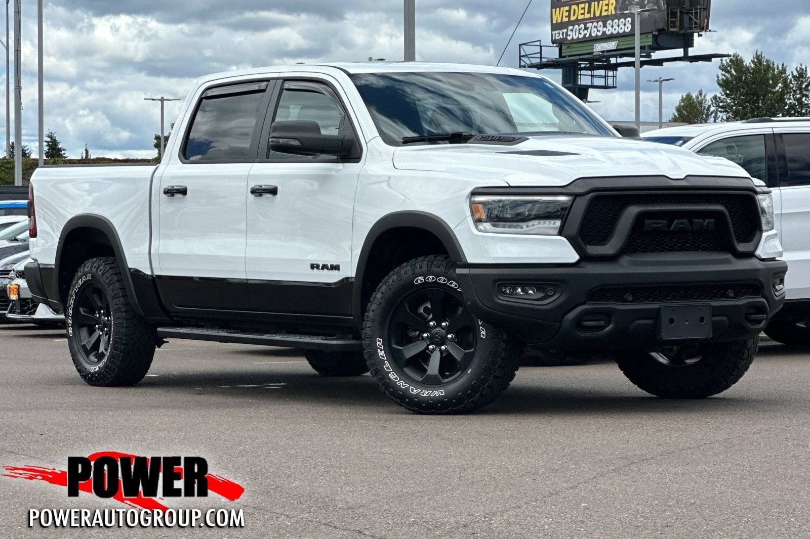 2024 RAM 1500 Rebel in Bright White Clea — front three-quarter view