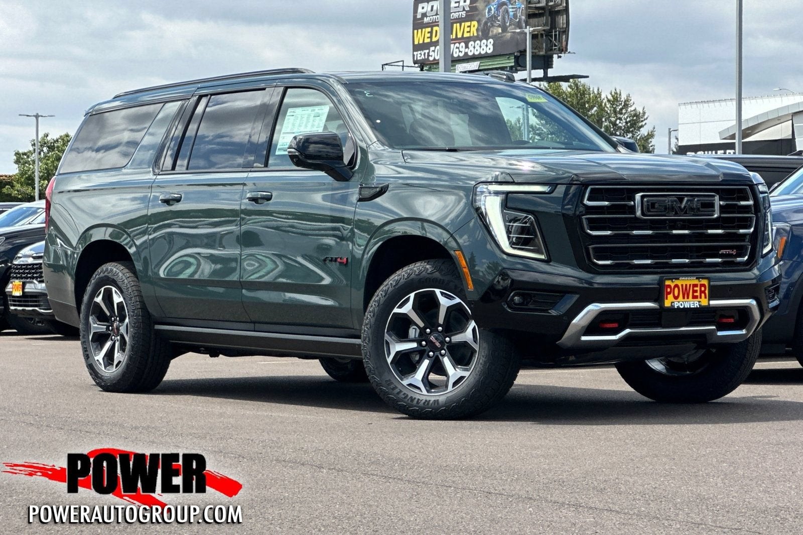 2026 GMC Yukon XL AT4 in Midnight Pine — front three-quarter view