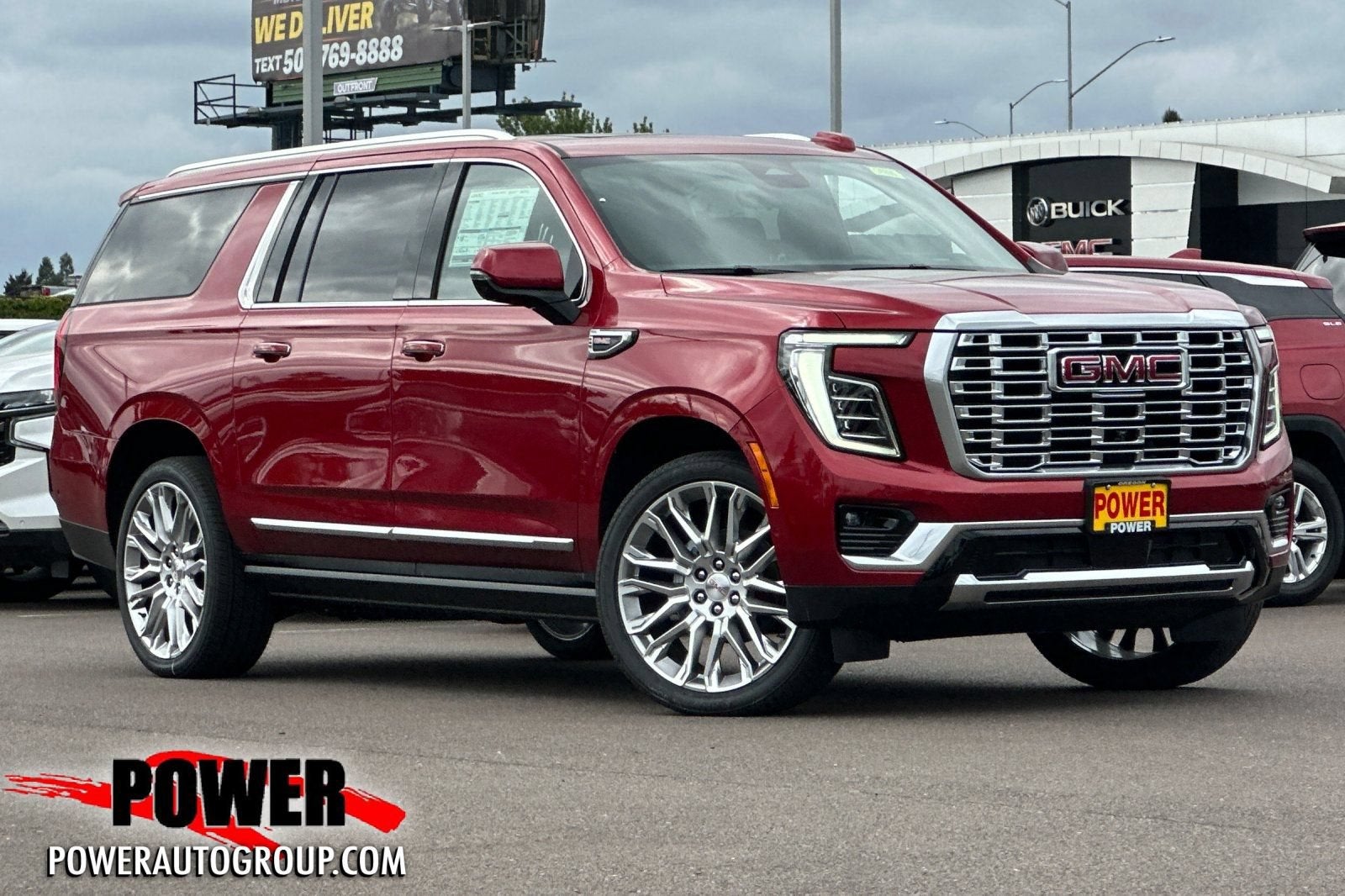 2026 GMC Yukon XL Denali in Volcanic Red Tintcoat — front three-quarter view