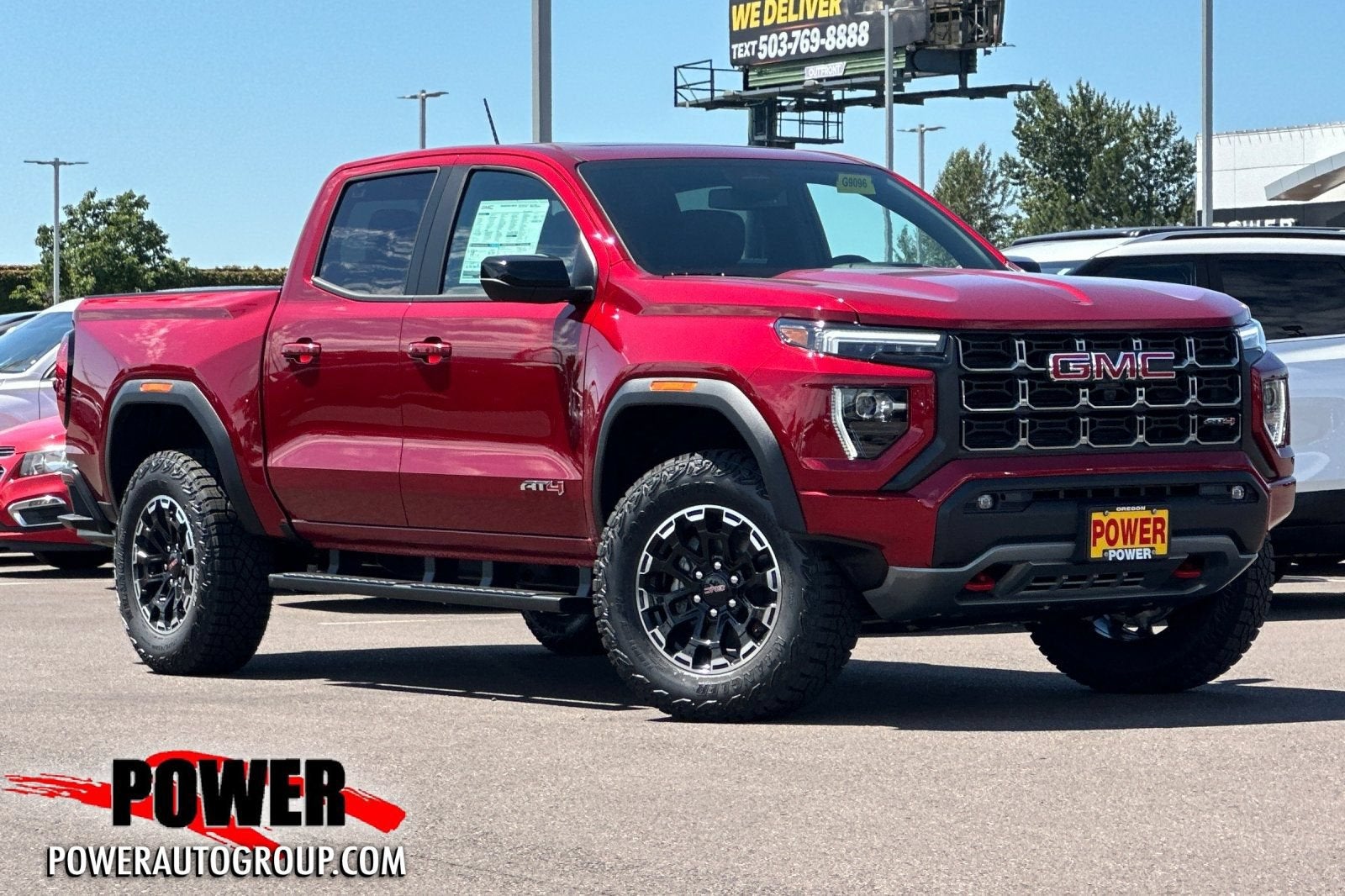 2026 GMC Canyon AT4 in Volcanic Red Tintcoat — front three-quarter view