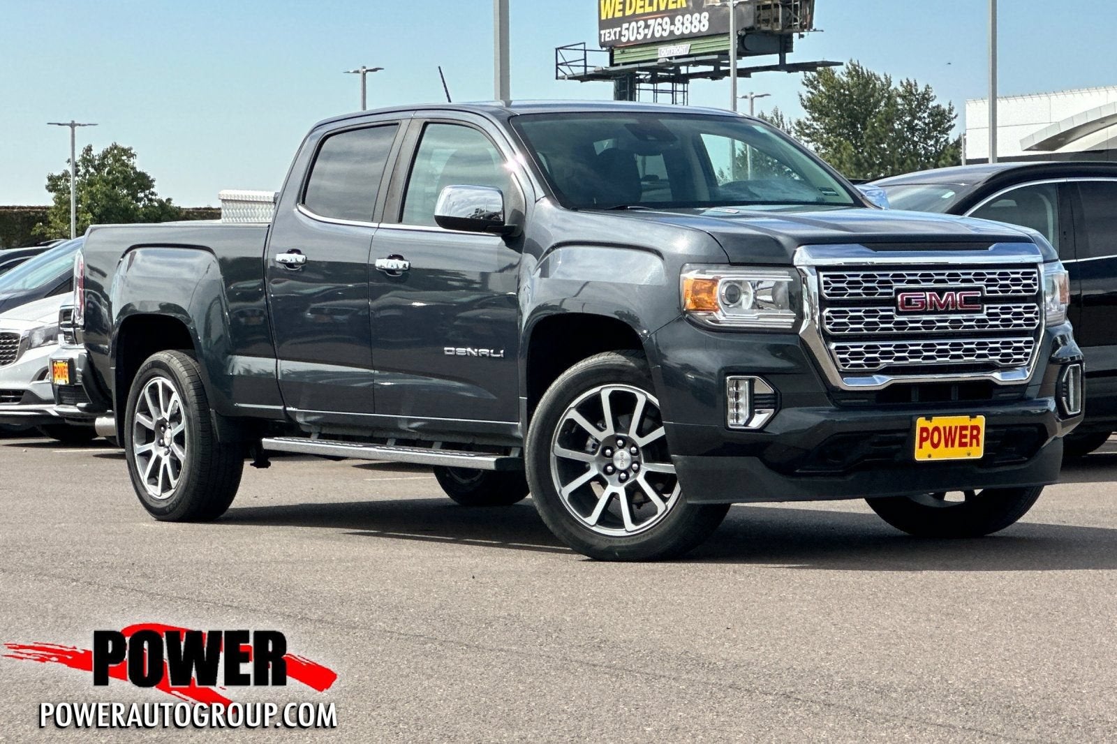 2021 GMC Canyon 4WD Denali in Hunter Metallic — front three-quarter view
