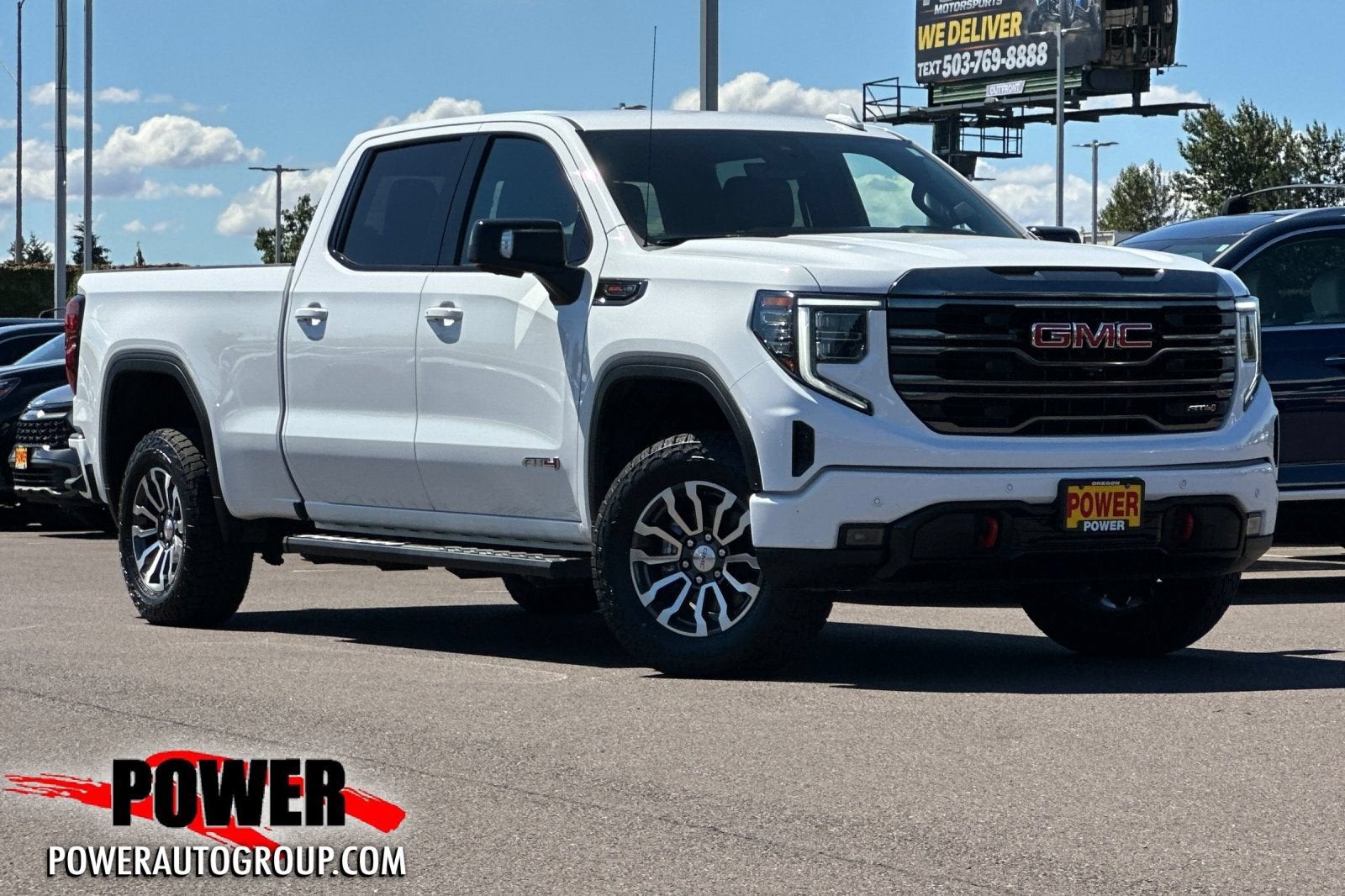 2023 GMC Sierra 1500 AT4 in Summit White — front three-quarter view