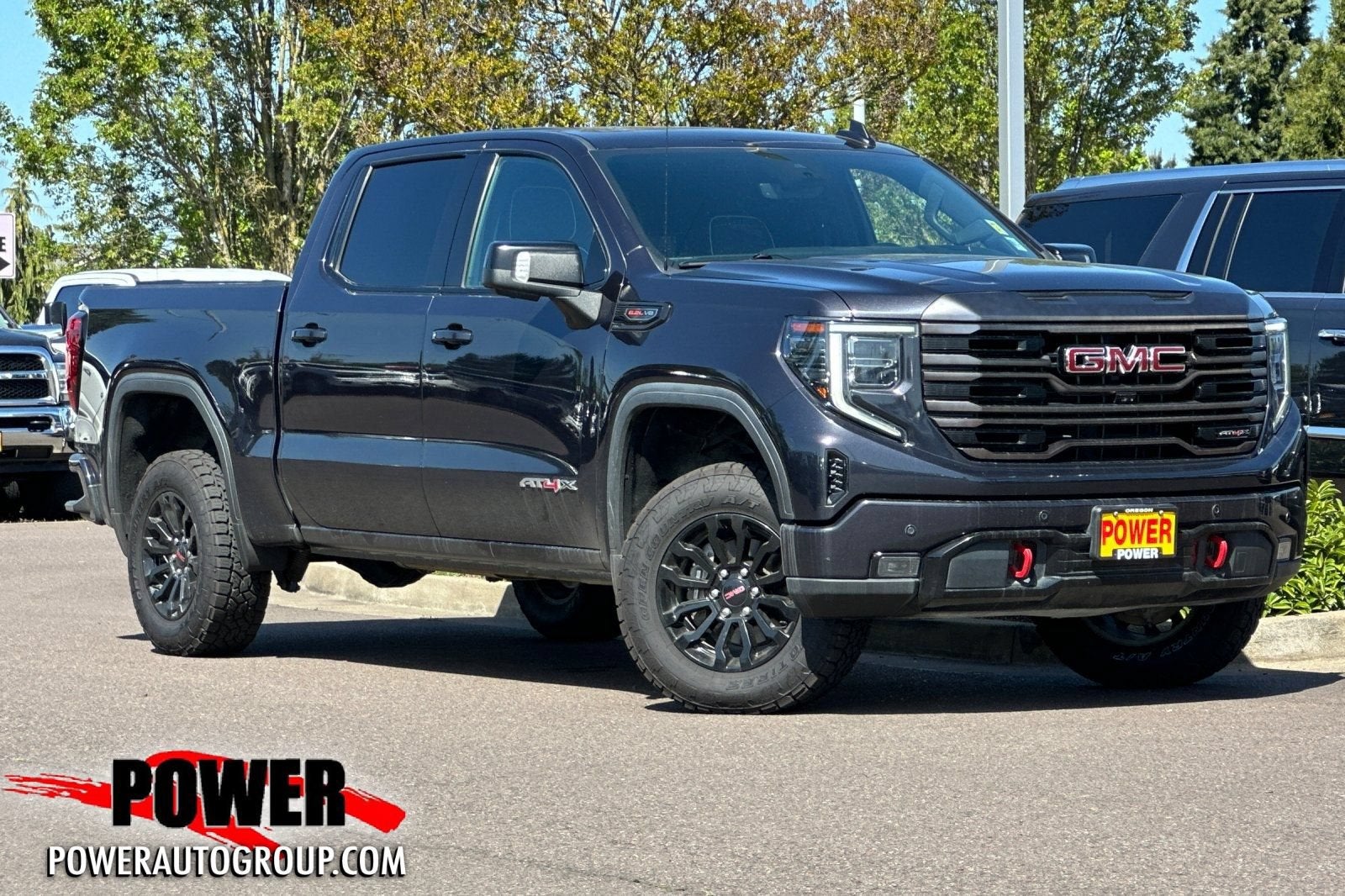 2023 GMC Sierra 1500 AT4X in Titanium Rush Metallic — front three-quarter view