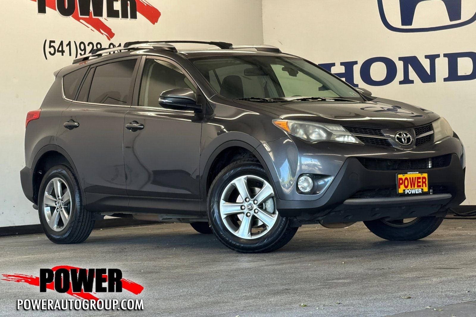 2015 Toyota RAV4 XLE in Magnetic Gray Metallic — front three-quarter view
