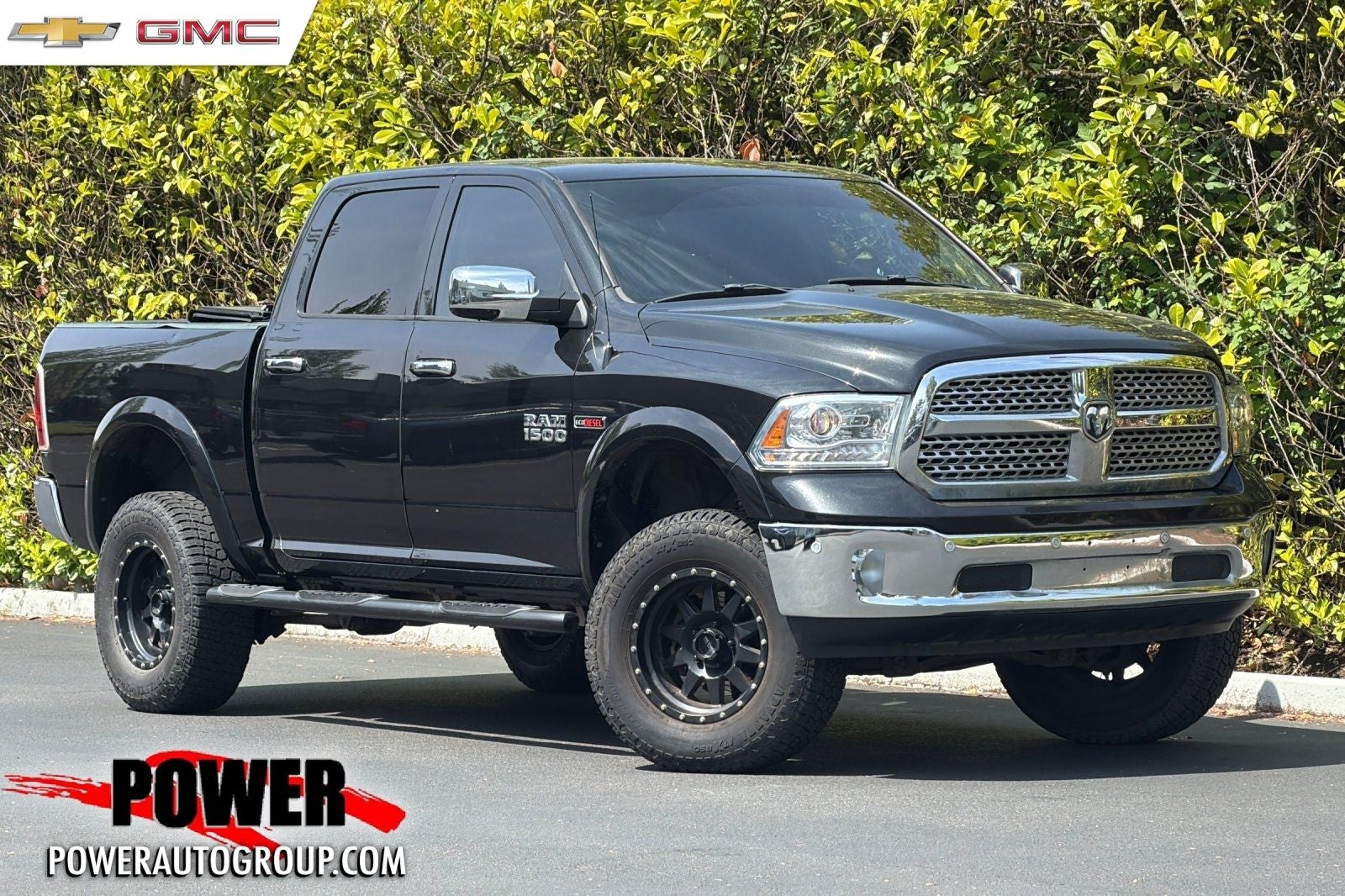 2018 RAM 1500 Laramie in Brilliant Black Crystal Pearlcoat — front three-quarter view
