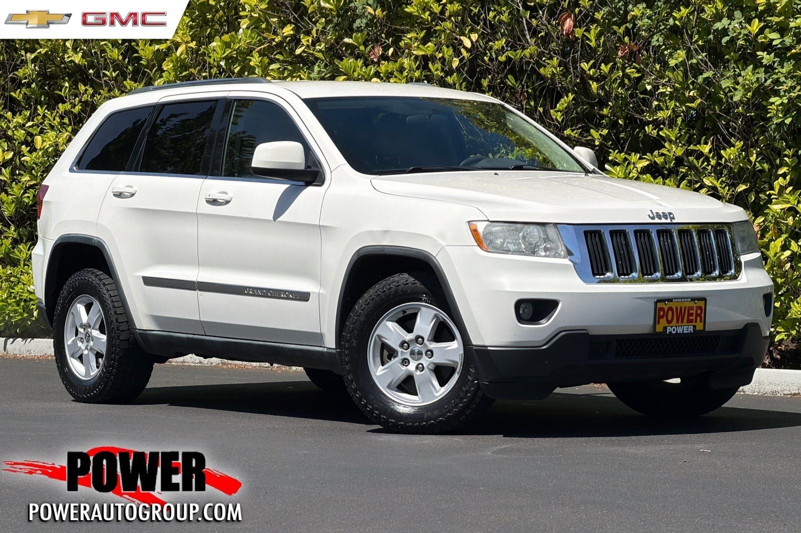 2011 Jeep Grand Cherokee Laredo in Stone White — front three-quarter view