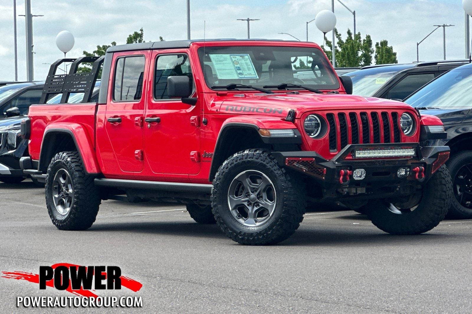 2020 Jeep Gladiator Rubicon in Firecracker Red Clearcoat — front three-quarter view