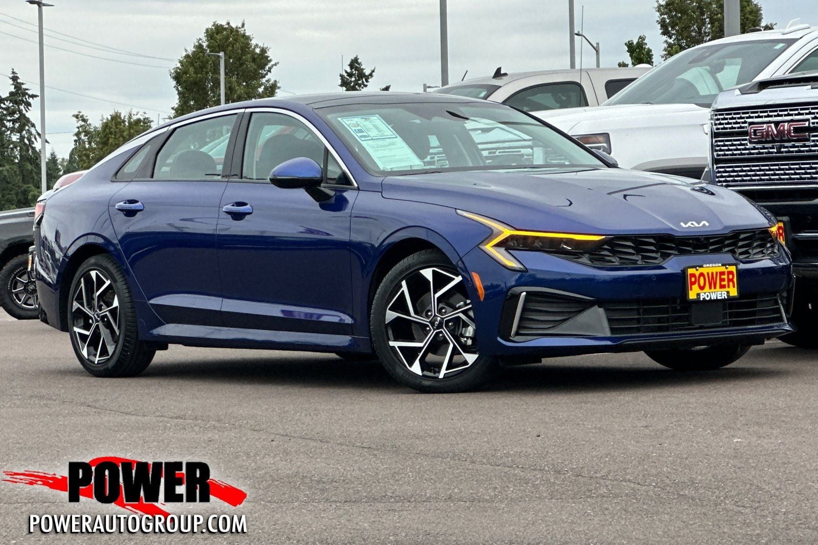 2025 Kia K5 EX in Yacht Blue — front three-quarter view